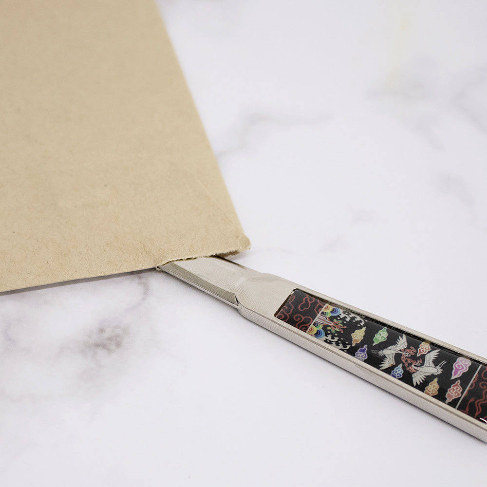 "Korean mother-of-pearl letter opener with traditional patterns"