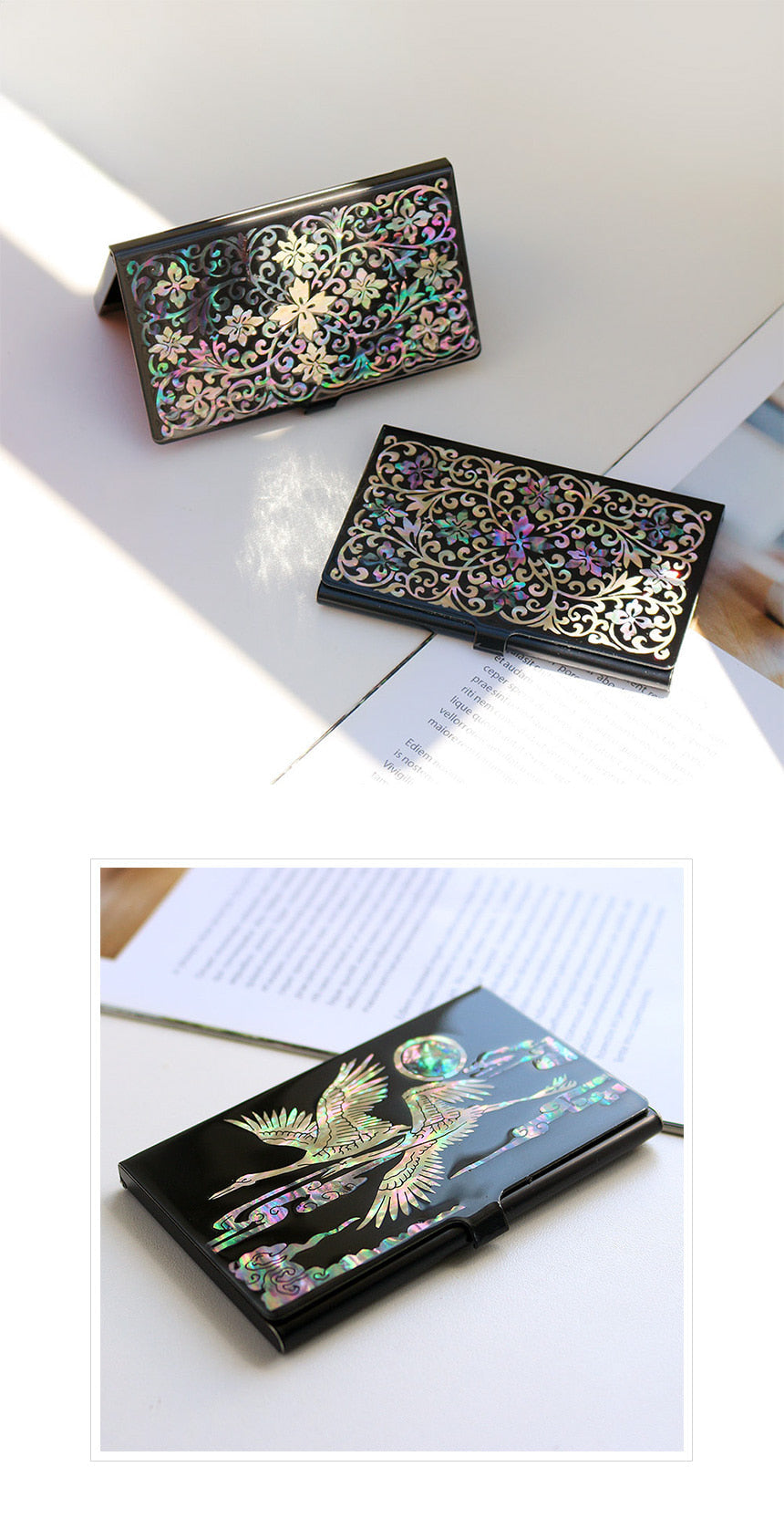Decorative black card cases with floral designs on a white surface.